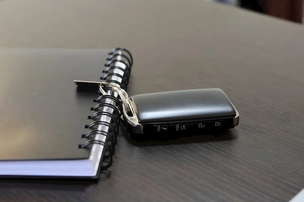 Car key fob resting on a notebook of Omaha SR-22 auto insurance notes